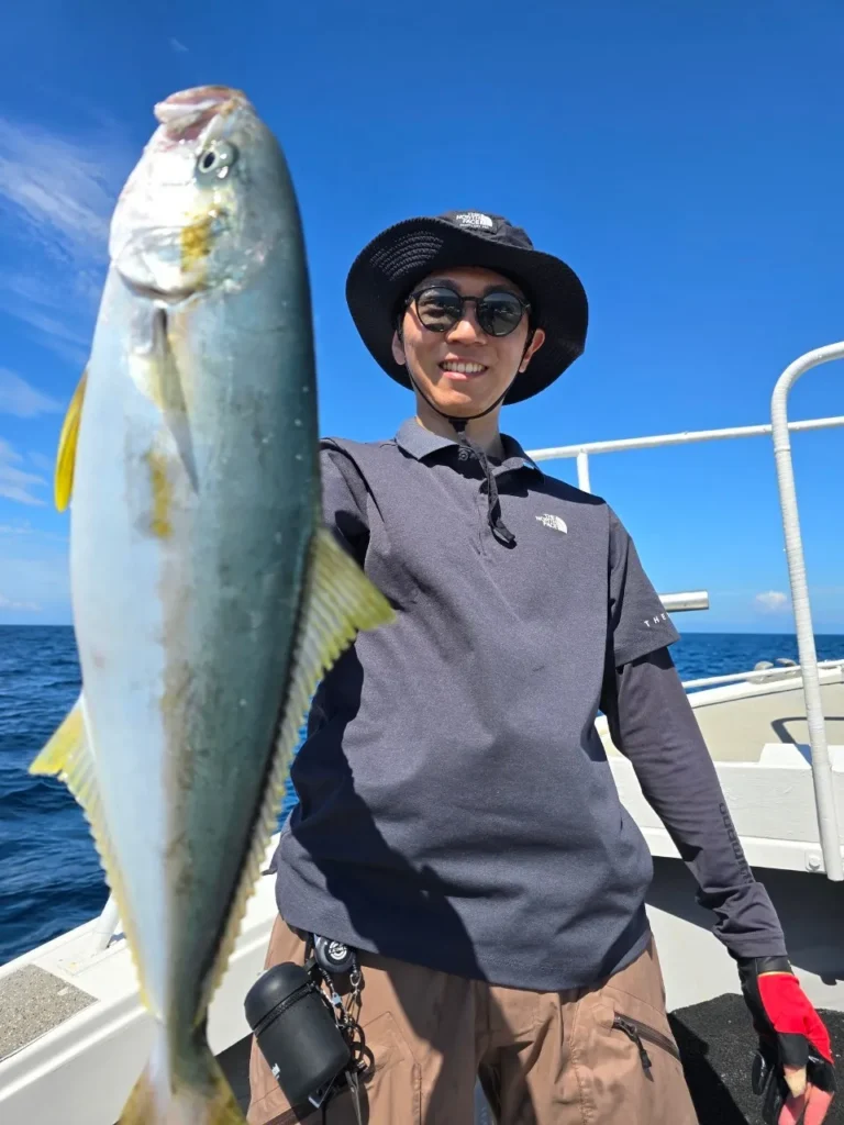 Mao Yoshimura, founder of Catch to Table Japan, holding a yellowtail