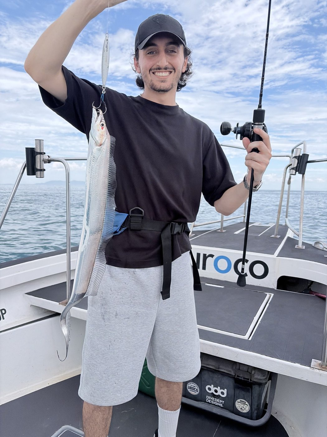 A guest holding the hairtail he caught