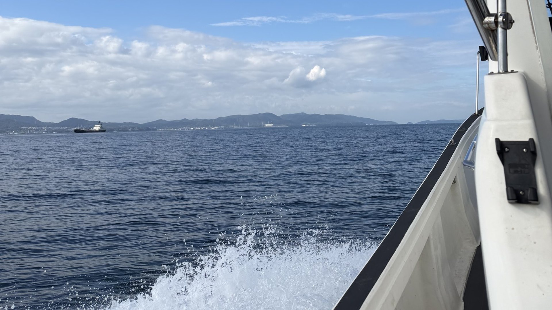 The boat running out across Osaka Bay, spray off the hull